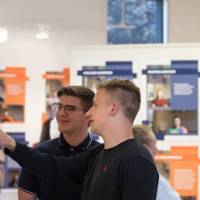 Two students interact with the exhibit